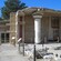 The ancient ruins of a columned building with frescoes painted on one of its walls